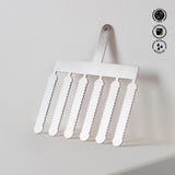 Metal spatula with serrated edges on a light gray background