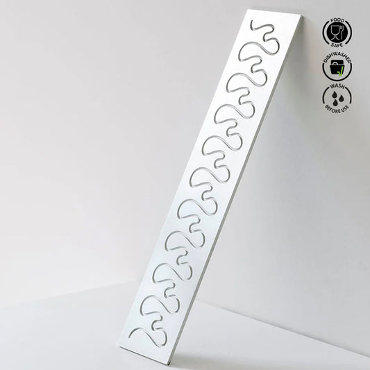 White plastic mold with wavy patterns on a light gray background