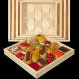 Wooden box of assorted pastries with a woven lid on a white background