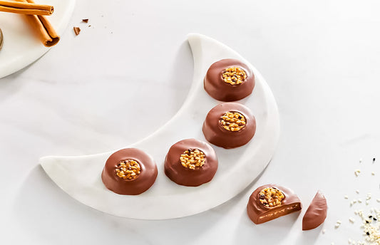 Cinnamon And Sesame Bonbon on a moon shaped plate