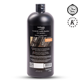 Bottle of vanilla extract with a black label on a white background