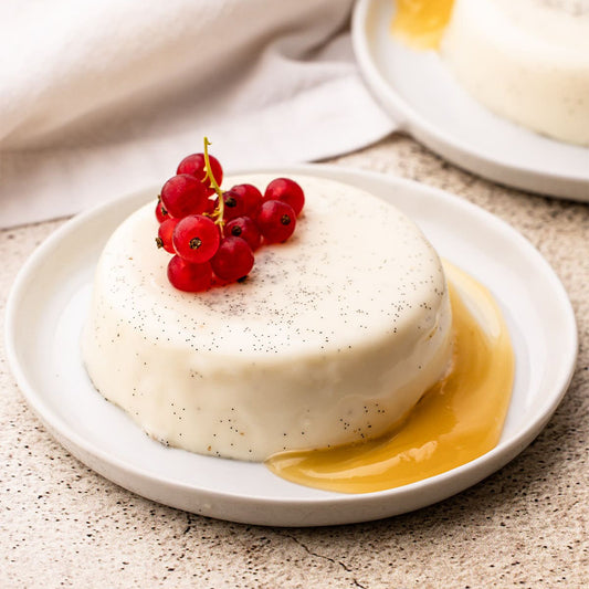White dessert with red berries on a beige plate