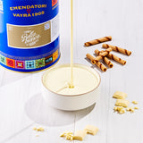 EVS09015White Chocolate Gourmet Variegato for Gelato & Pastry 6kg | Bella Bianca Bella Bianca ice cream being poured into a bowl with wafers and a can of Emendatori Vayra 1905 in the background.