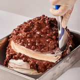 EVS09094 Rock 'n Rolla Chocolate Hazelnut Variegato with Wafer Crunch 6kg | Ripple Cream Chocolate cake being frosted with a spatula Desserts