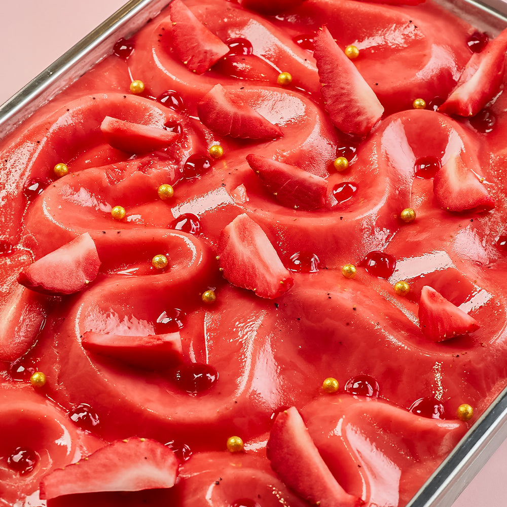 Close-up of a red jelly dessert with watermelon slices and gold seeds on a wITH Strawberry Gelato, Ice Cream