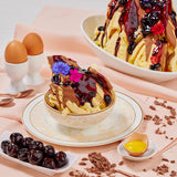 Dessert bowl with waffles, chocolate sauce, and berries 