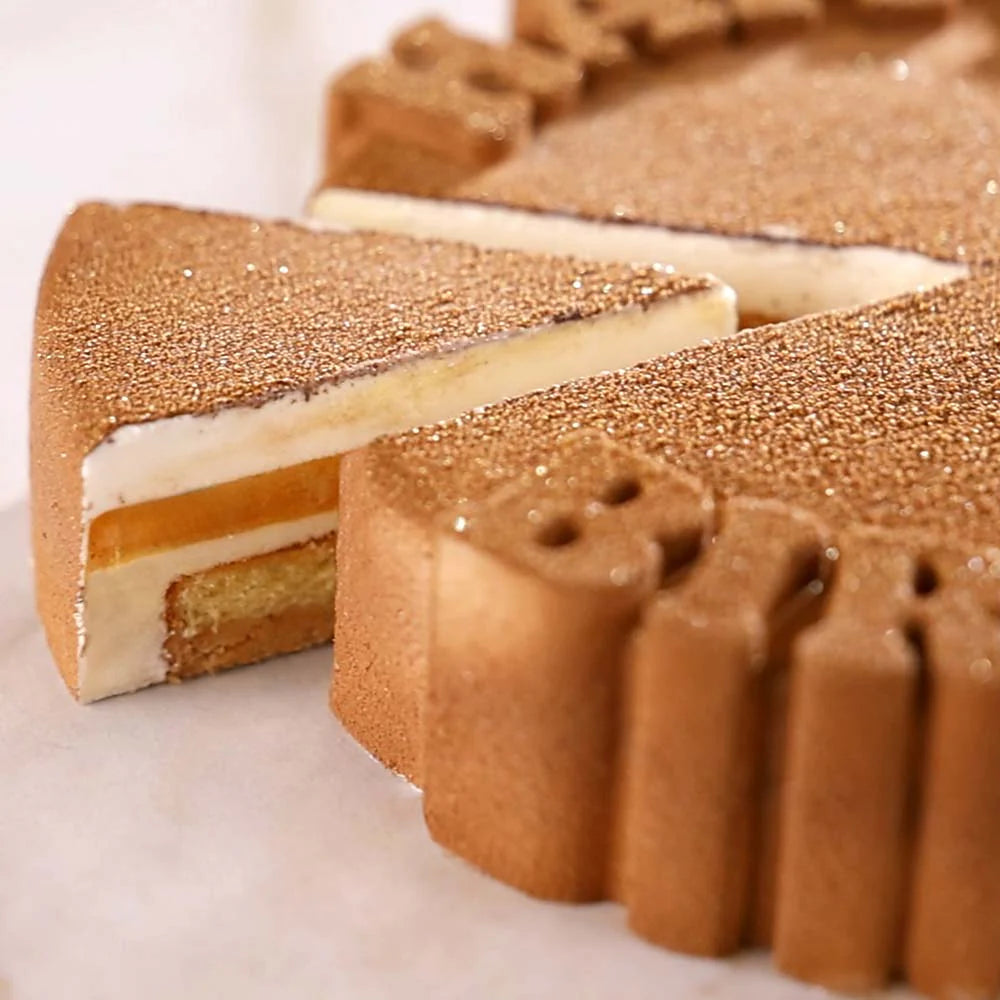 Close-up of a layered dessert with a golden-brown crust on a white background Pavoni Silicon Mould PAVOCAKE "Happy Birthday" KE096
