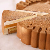 Close-up of a layered dessert with a golden-brown crust on a white background Pavoni Silicon Mould PAVOCAKE "Happy Birthday" KE096