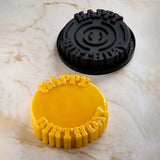 Black and yellow cookie cutters with 'Happy Birthday' text on a marble surface
