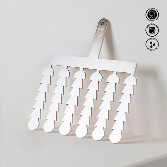 White spatula with multiple small spatulas attached, on a light gray background