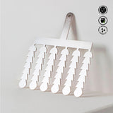 White spatula with multiple small spatulas attached, on a light gray background