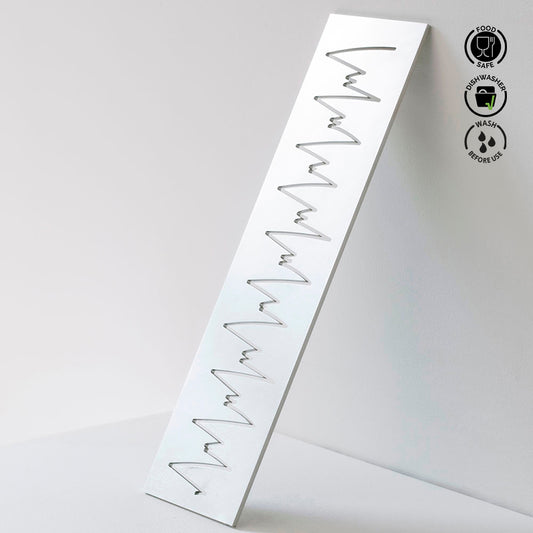 Metallic wavy strip on a white background with food safe and dishwasher safe icons.