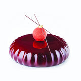 Red jelly dessert with a cherry on top on a white background
