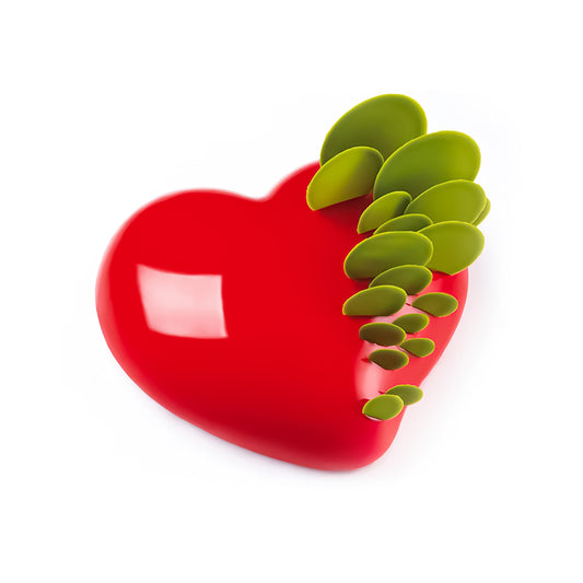 Red heart-shaped object with green leaves on a white background