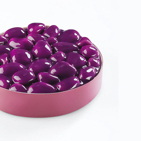Purple heart-shaped objects in a pink dish on a white background