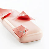 Pink jewelry box with earrings on a white background