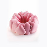 Pink textured object with white specks on a white background