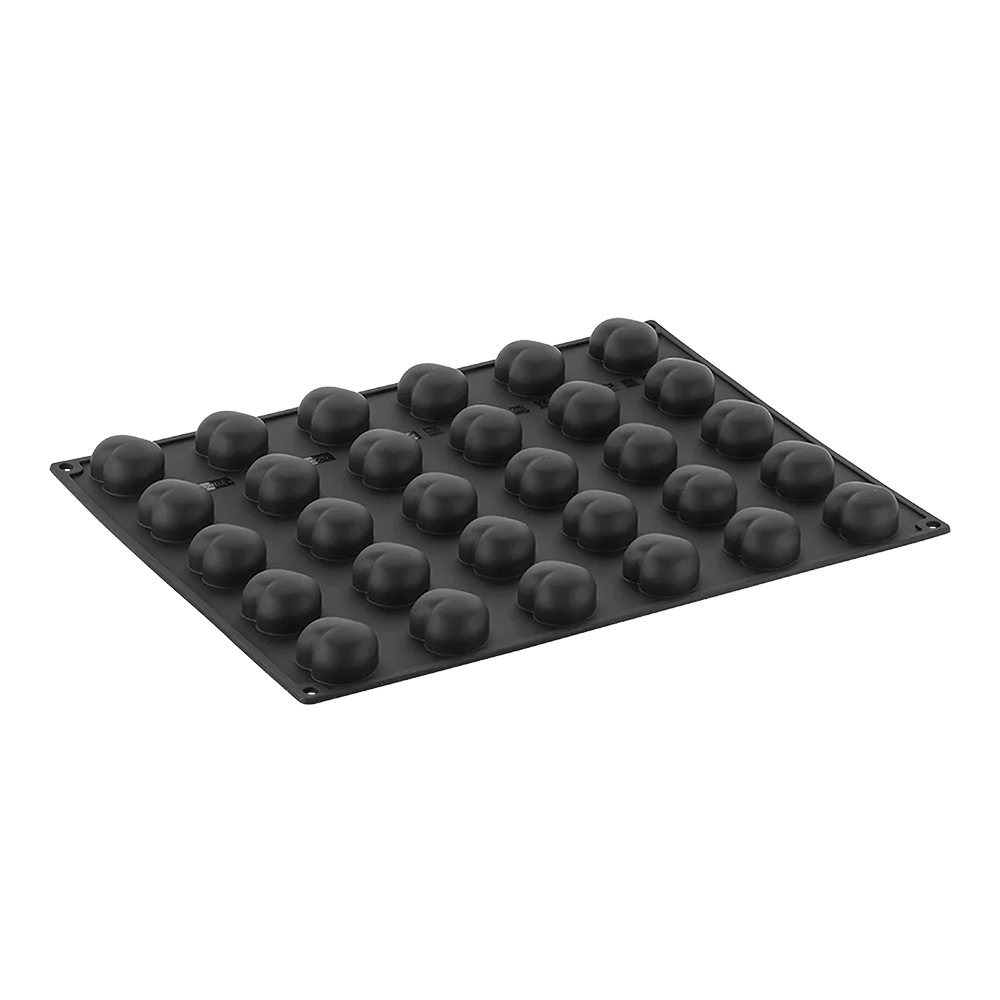Black silicone mold with spherical cavities on a white background