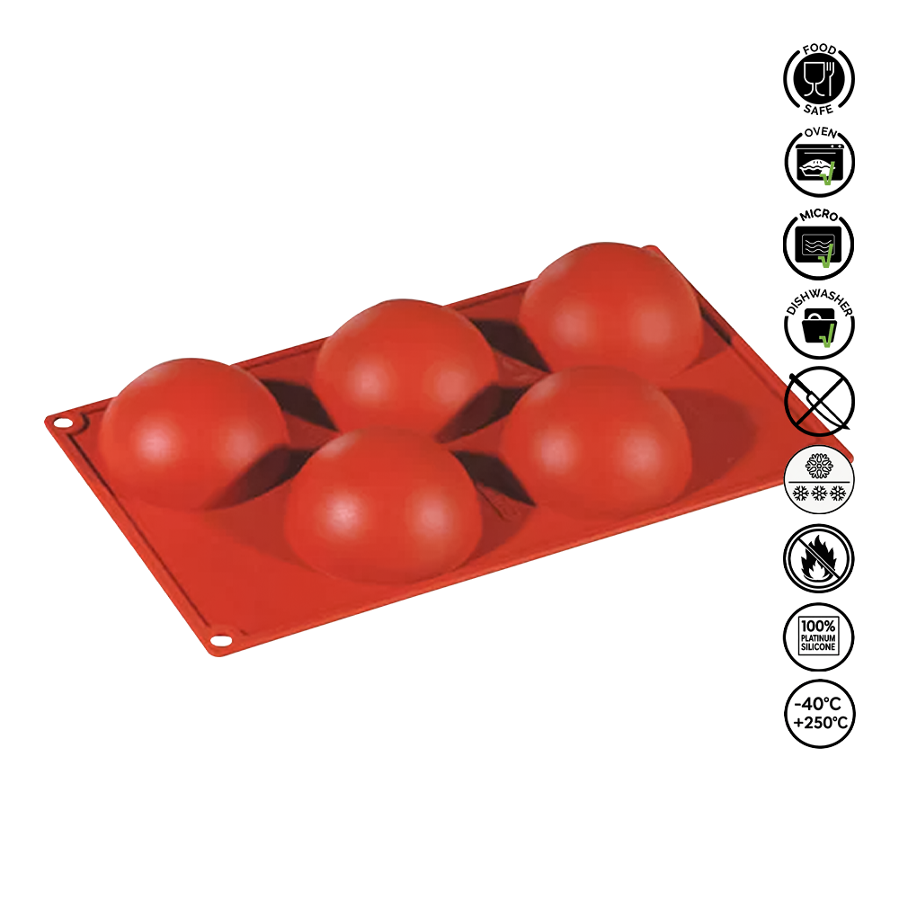 Red silicone mold with spherical cavities on a white background