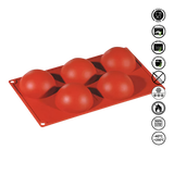 Red silicone mold with spherical cavities on a white background