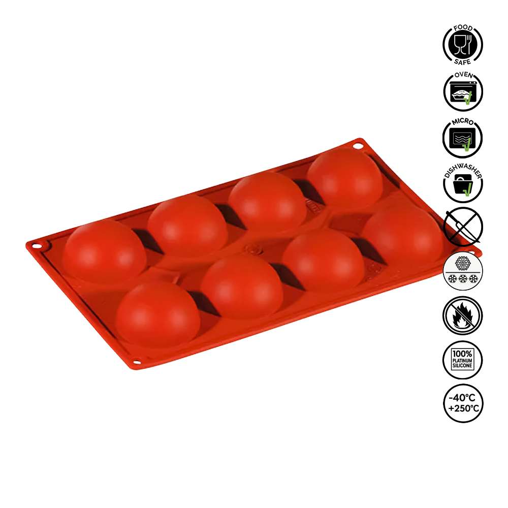 Red silicone mold with spherical cavities on a white background
