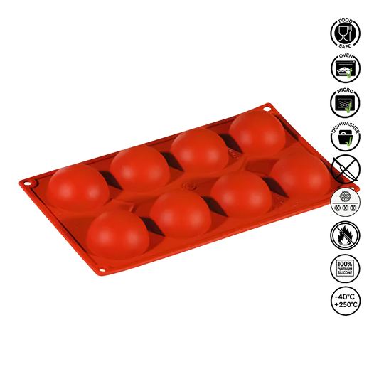 Red silicone mold with spherical cavities on a white background