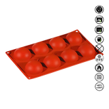 Red silicone mold with spherical cavities on a white background