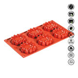Red silicone mold with star-shaped cavities on a white background