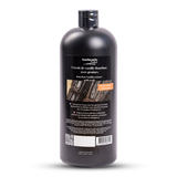Black bottle of bourbon vanilla extract with a label on a white background