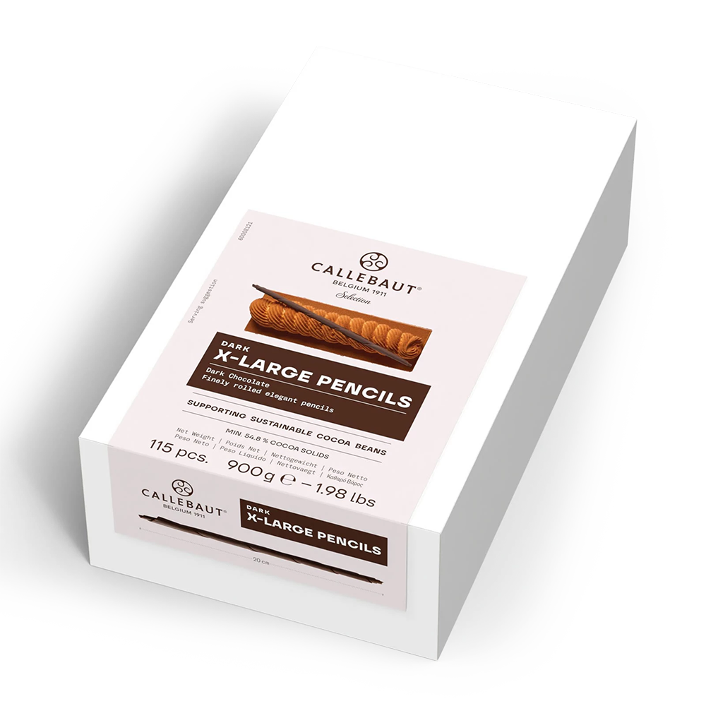 A white rectangular box of Callebaut  X-Large Pencils, shown at an angle on a clean white background. The front label features a light pink background with brown and black text and an illustration of chocolate-dusted cocoa bean pencils.