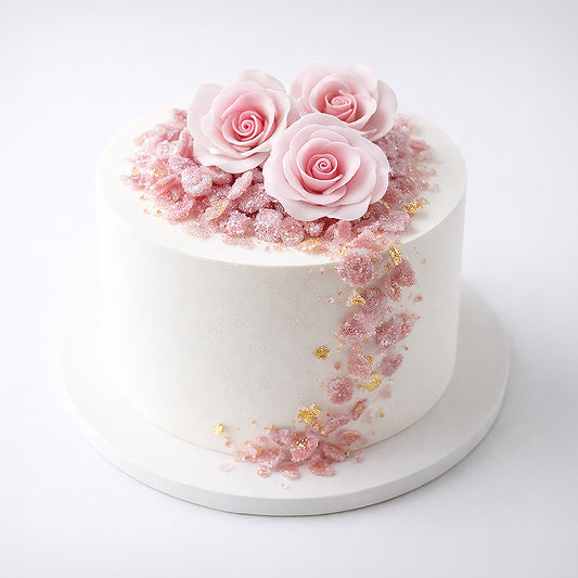 White cake with pink roses and decorative elements on a white background